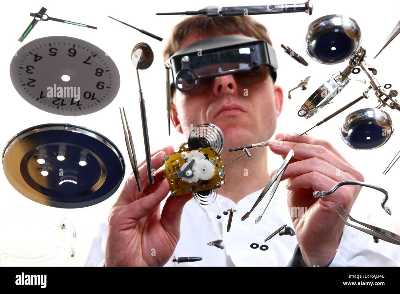 Precision mechanics, watchmaker repairing a clockwork, alarm clock