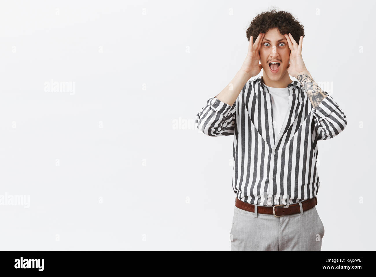 Man in awkward situation shouting trying not look aside holding palms ...