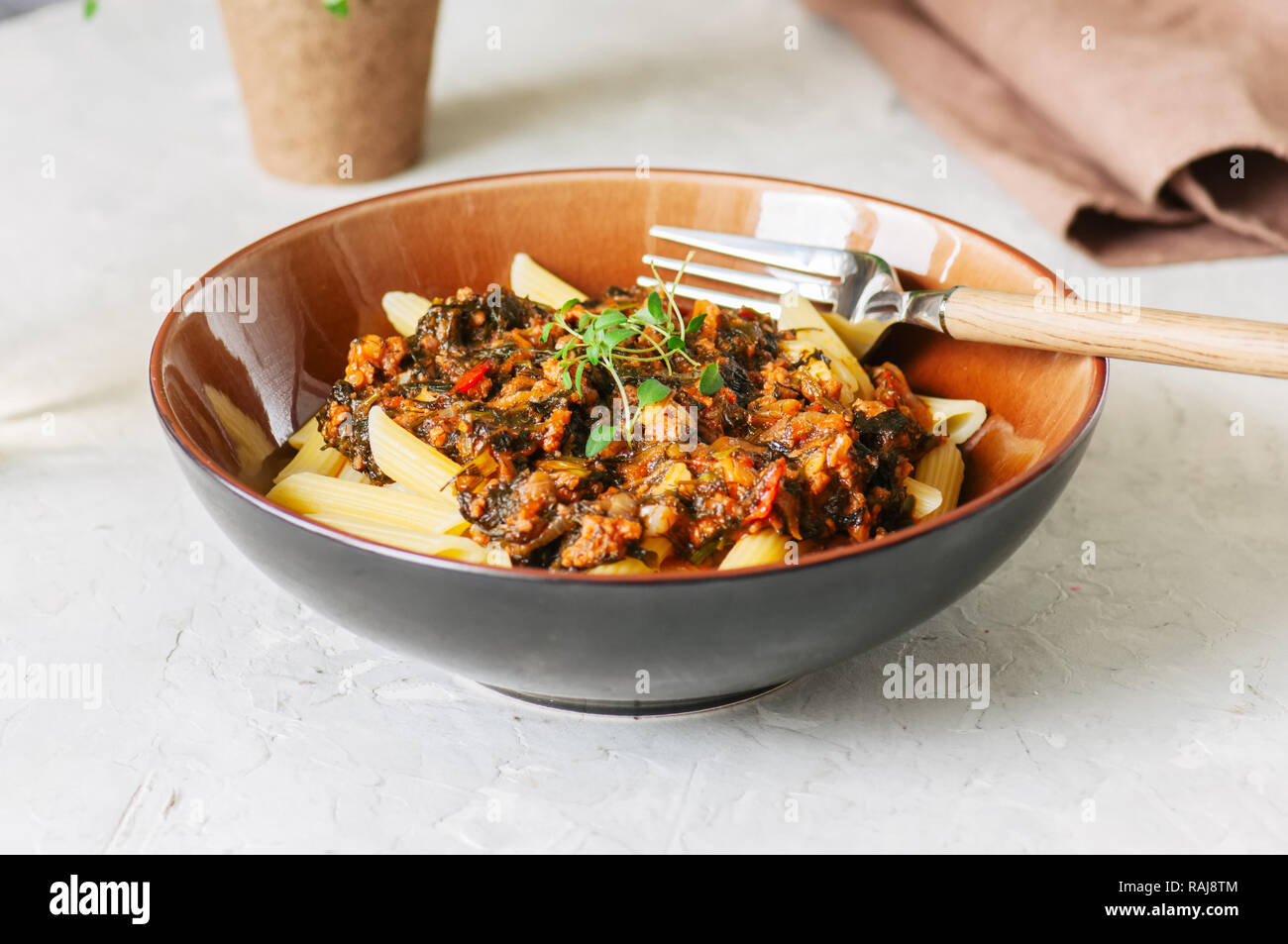 Tomato sauce ground beef pasta on a white stone background. Toned Stock
