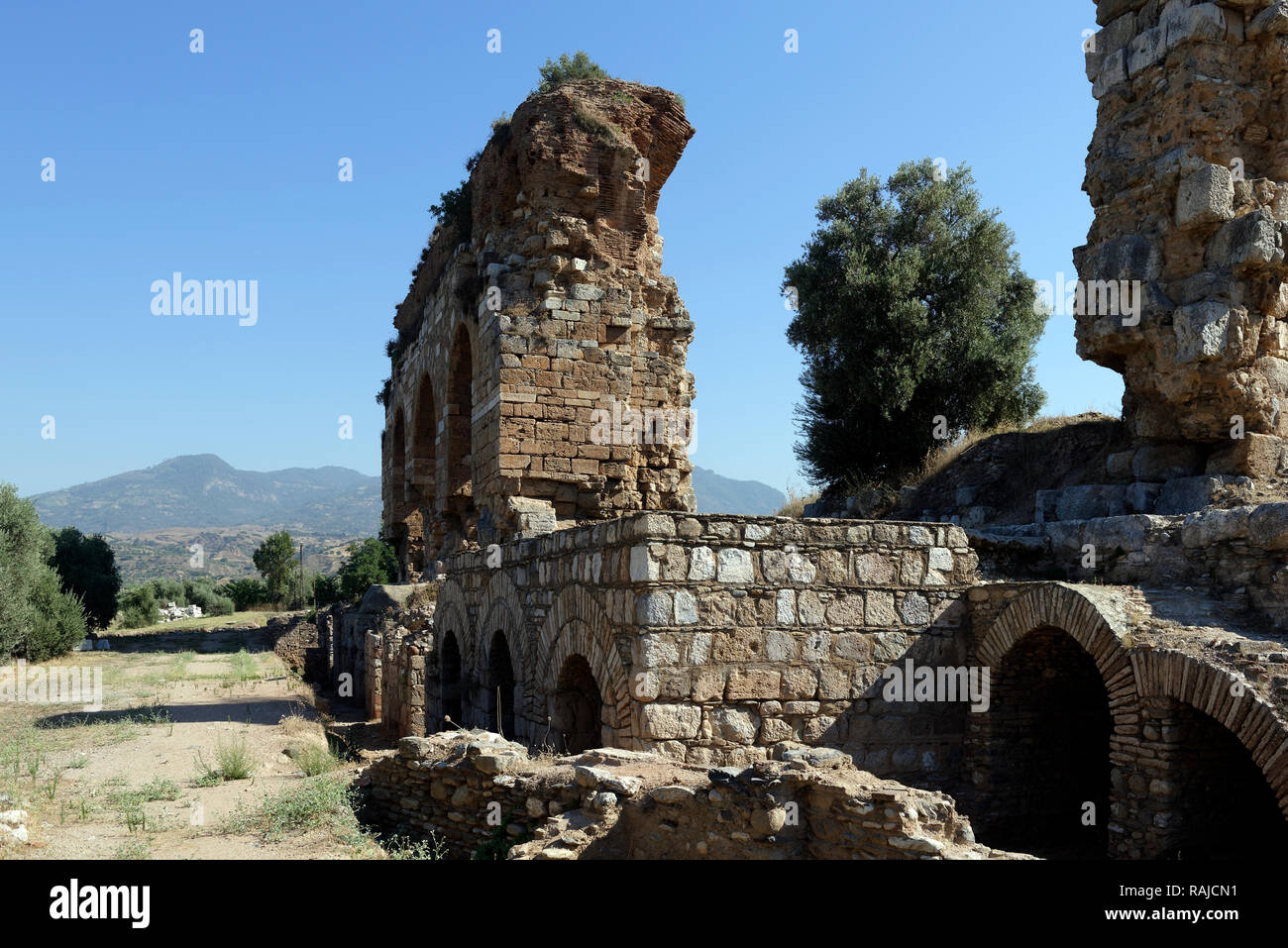 The imposing three arched structure that is part of the Bath-Gymnasium complex, ancient city of Tralleis, Aydin, Anatolia, Turkey. Dated to the 3rd ce Stock Photo