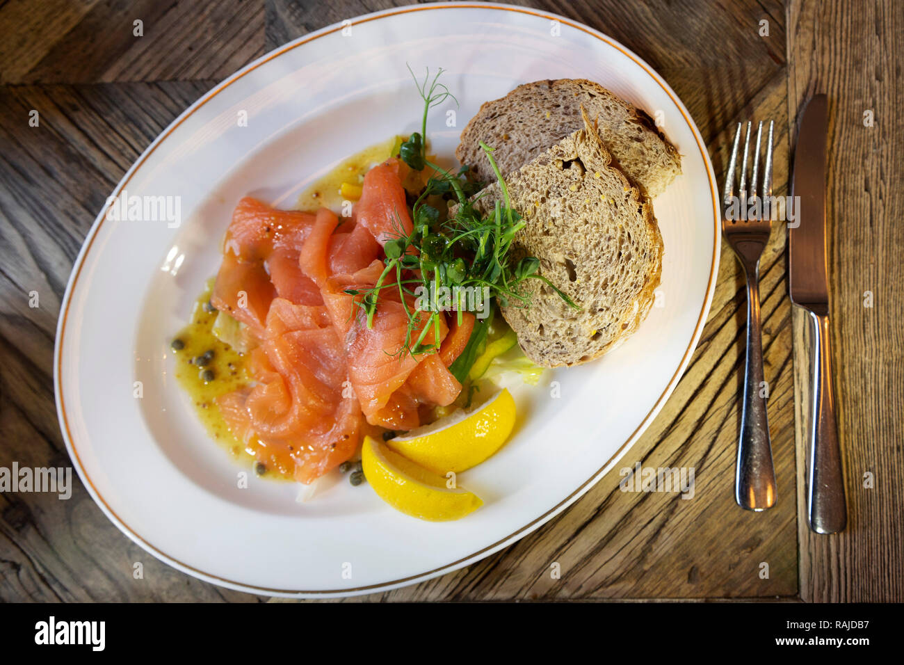 Smoked salmon served with wholegrain bread and wedges of lemon. The salmon is Scottish. Stock Photo