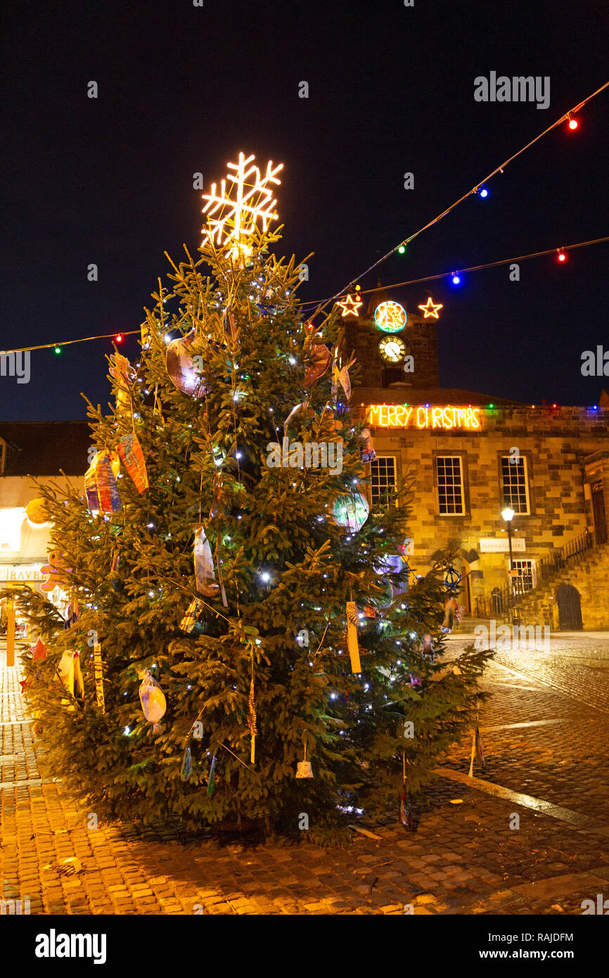Christmas tree in Alnwick, Northumberland. The decorated tree stands on market square, in front of the town hall. Stock Photo