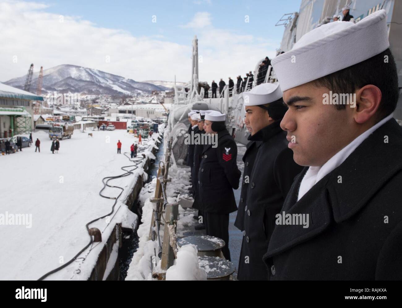 OTARU, Japan (Feb. 03, 2017) Sailors assigned to the forward-deployed Arleigh Burke-class guided-missile destroyer USS McCampbell (DDG 85) man the rails as the ship pulls into the city of Otaru. McCampbell is on patrol in the 7th Fleet area of operations in support of security and stability in the Indo-Asia-Pacific region. Stock Photo