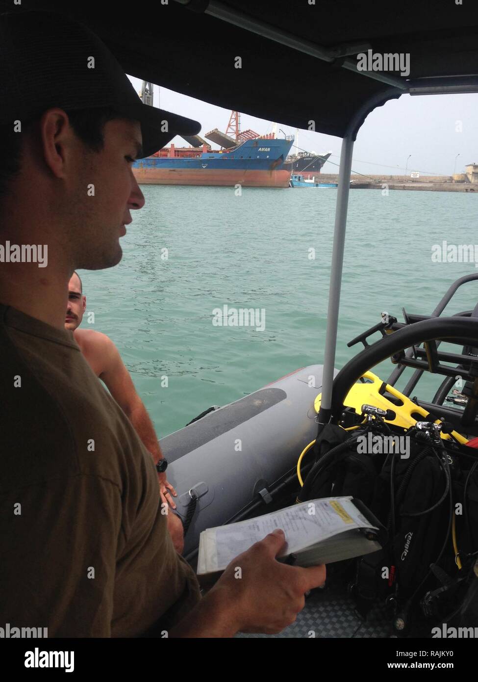 Camp Lemonnier, Djibouti (Feb, 07,2017) Lt. j.g. Riley Harsh, assigned to Explosive Ordnance Disposal Mobile Unit 8, conducts a dive supervisor brief prior to splashing divers in the Port of Djibouti.  U.S. 6th Fleet, headquartered in Naples, Italy, conducts the full spectrum of joint and naval operations, often in concert with allied, joint, and interagency partners, in order to advance U.S. national interests and security and stability in Europe and Africa. Stock Photo