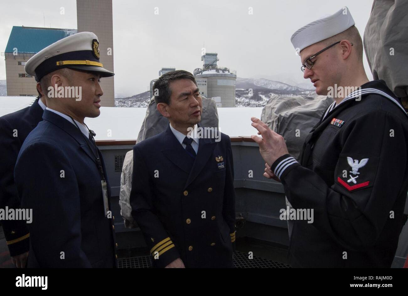 OTARU, Japan (Feb. 04, 2017) Gunner’s Mate 3rd Class Austin Aumiller, assigned to the forward-deployed Arleigh Burke-class guided-missile destroyer USS McCampbell (DDG 85), gives a tour of the ship to members of Japan Coast Guard after arriving at Otaru, Japan. McCampbell is on patrol in the 7th Fleet area of operations in support of security and stability in the Indo-Asia-Pacific region. Stock Photo