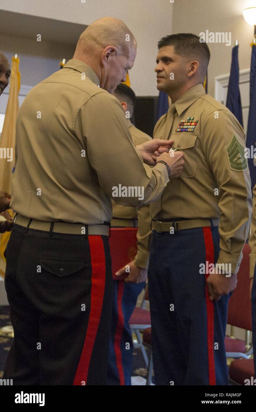 Commandant of the Marine Corps Gen. Robert B. Neller, left, pins a Navy ...