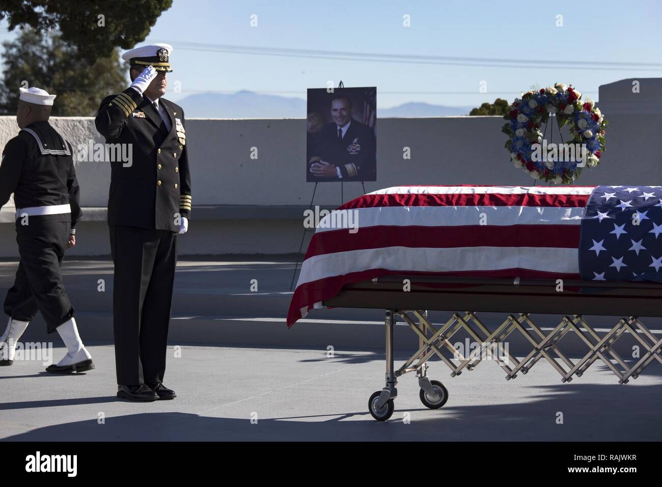 SAN DIEGO (Feb. 13, 2017) Capt. Cory Cathcart, force chaplain, Naval Special Warfare Command, salutes the casket of retired Rear Adm. (SEAL) Richard Lyon during a memorial service held at Fort Rosecrans National Cemetery. Adm. Lyon passed away Feb. 3, 2017 at the age of 93. He served more that 40 years in the Navy, including tours in WWII and the Korean War and was the first SEAL admiral. Stock Photo