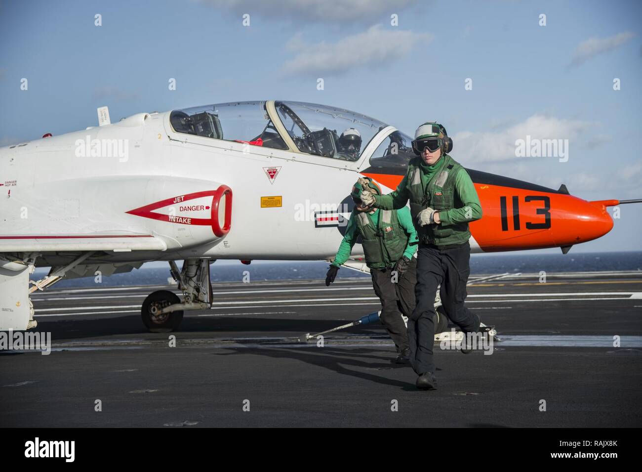ATLANTIC OCEAN (Feb. 10, 2017) Aviation Boatswain’s Mate Airman (Equipment), Bradley Stine, right, and Aviation Boatswain’s Mate 2nd Class (Equipment) Tyler Cantrall, complete their preflight inspection on the arresting gear of a T-45C Goshawk assigned to Carrier Training Wing (CTW) 1 prepares to launch from the flight deck of the aircraft carrier USS Dwight D. Eisenhower (CVN 69) (Ike). Ike is currently conducting aircraft carrier qualifications during the sustainment phase of the Optimized Fleet Response Plan (OFRP). Stock Photo