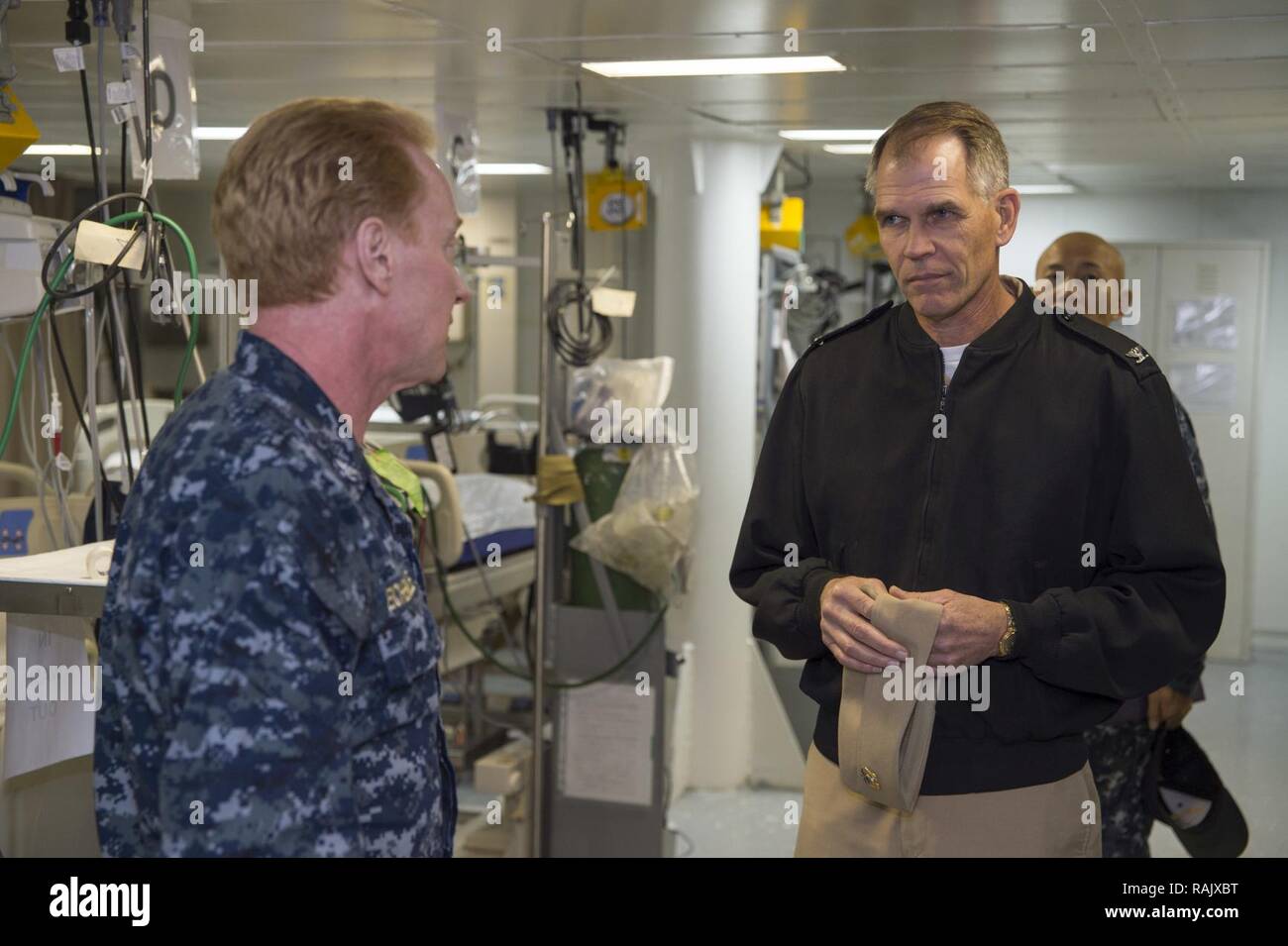 SASEBO, Japan(Feb. 14, 2017) Capt. Kurt Eichenmuller, senior medical officer of amphibious assault ship USS Bonhomme Richard (LHD 6), describes Bonhomme Richard’s medical emergency response capabilities to Capt. David O. Bynum, chaplain, U.S. Pacific Fleet, during a ship tour. Bonhomme Richard, forward-deployed to Sasebo, Japan, is serving forward to provide a rapid-response capability in the event of a regional contingency or natural disaster. Stock Photo