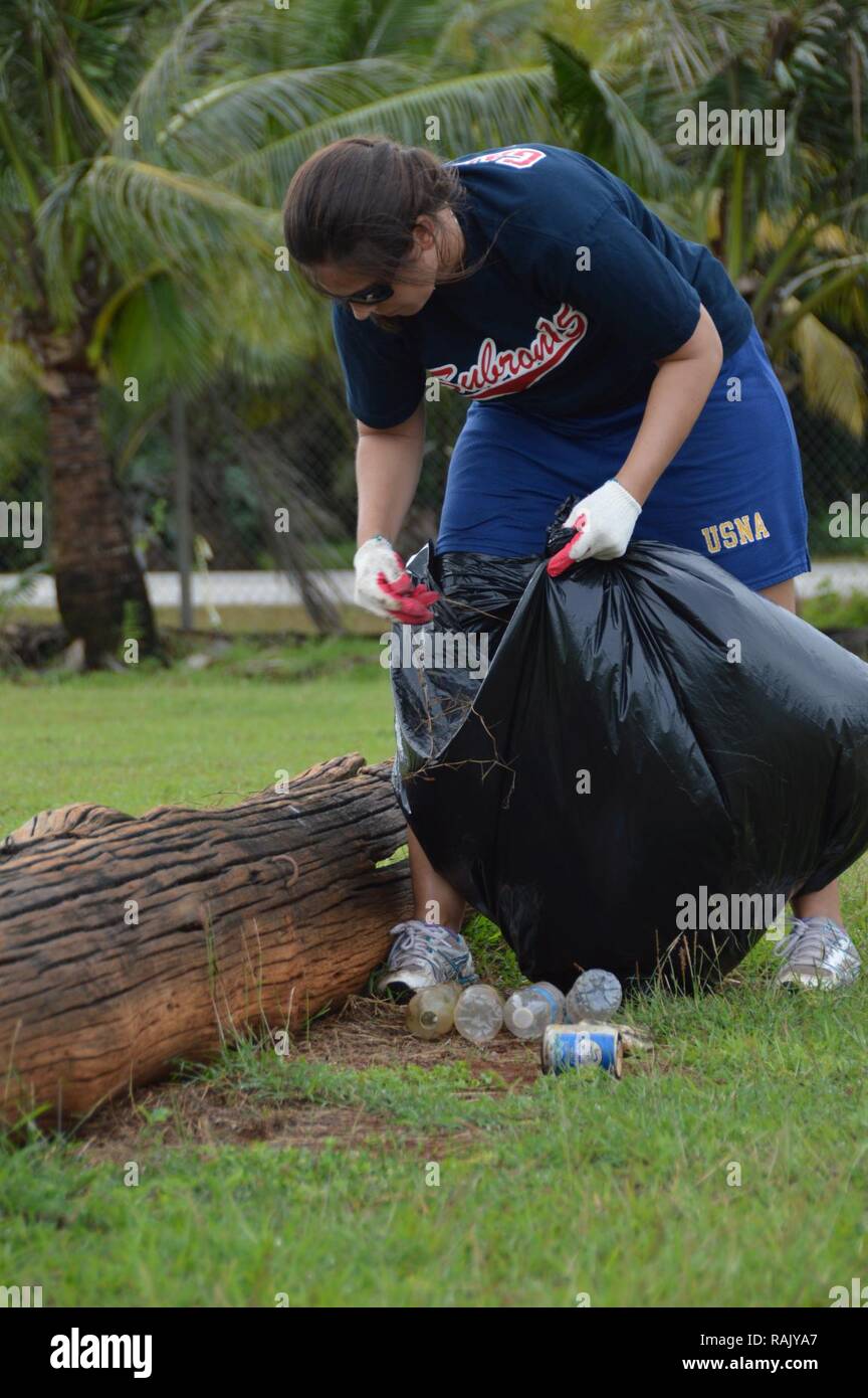 MANGILAO, Guam (Feb. 3, 2017)  Lt. Lauren Spaziano, public affairs officer, Commander, Submarine Squadron 15 (COMSUBRON 15), picks up trash at a local football field during a community relations (COMREL) cleanup project at Eagle’s Field on Friday, Feb. 3. The COMREL was a combined effort by Sailors, Soldiers, community volunteers and representatives from the Government of Guam to combat the vandalism and illegal dumping on the grounds. Stock Photo