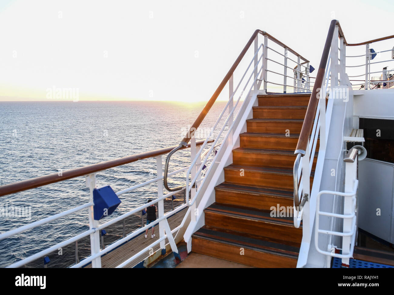 Railing and stairs of a cruise ship at sunset Stock Photo - Alamy