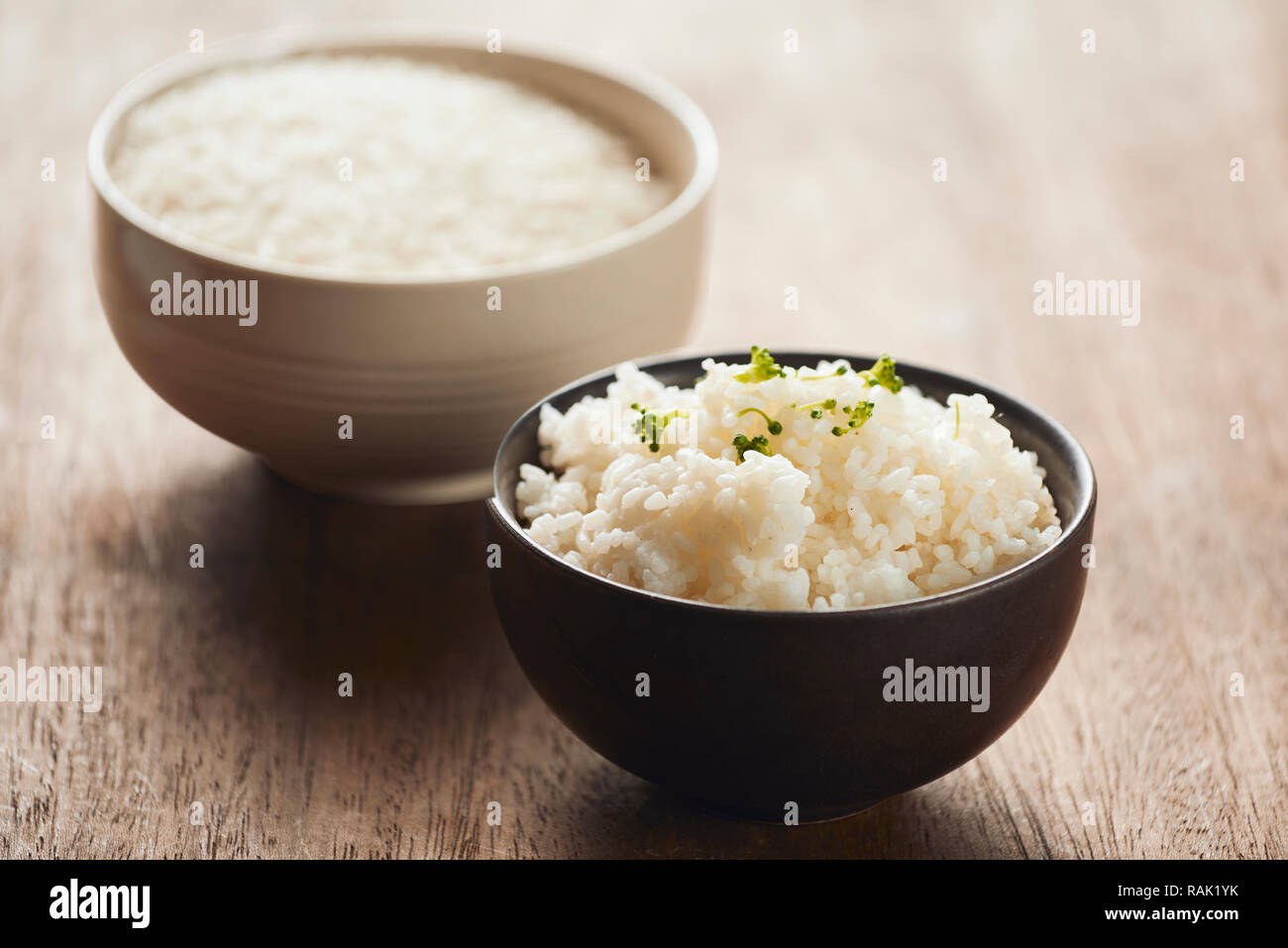 cooked jasmine rice and raw organic rice Stock Photo