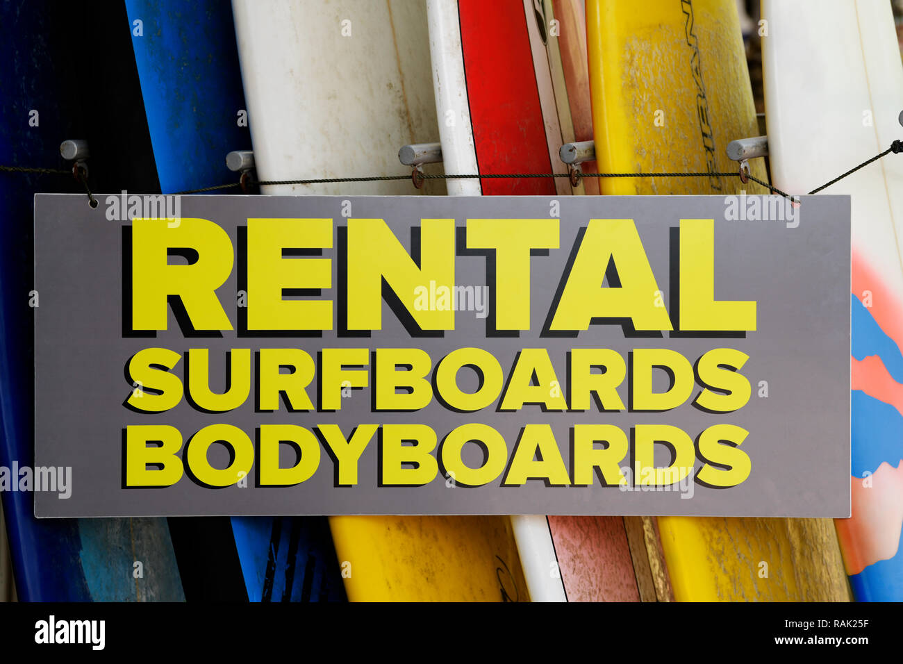 Durban, closeup detail of rental sign hanging next to surfboards for