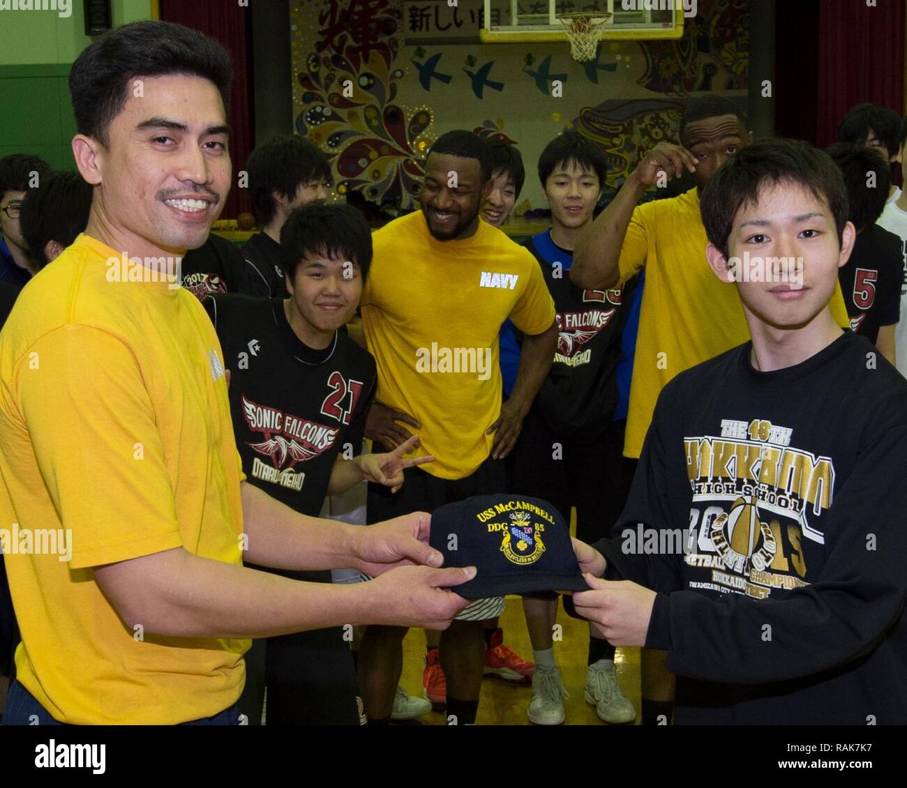OTARU, Japan (Feb. 05, 2017) Ship’s Serviceman 1st Class Michel Tolentino, assigned to the forward-deployed Arleigh Burke-class guided-missile destroyer USS McCampbell (DDG 85), exchanges gifts with Yuma Mizoguchi from the Meiho High School basketball team while visiting Otaru, Japan. McCampbell is on patrol in the 7th Fleet area of operations in support of security and stability in the Indo-Asia-Pacific region. Stock Photo