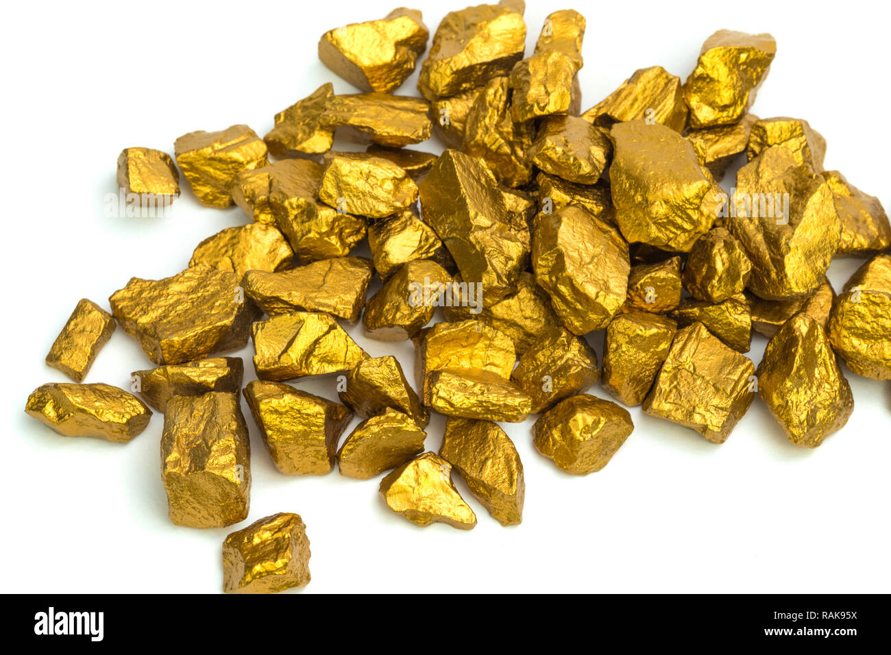 A pile of gold nuggets or gold ore isolated on white background ...