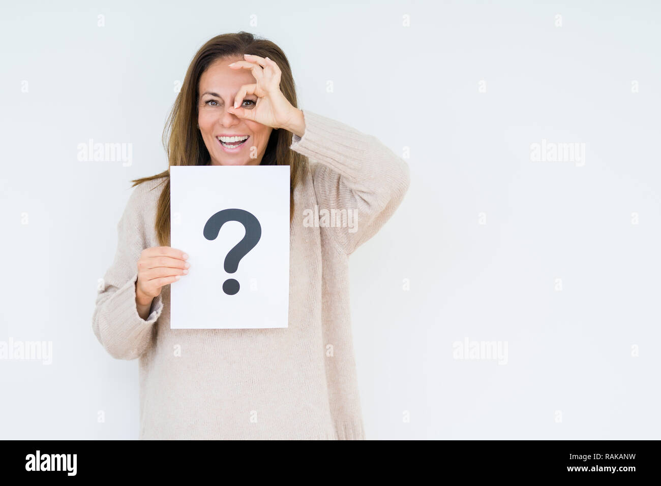 Middle age woman thinking and holding paper with question mark symbol ...