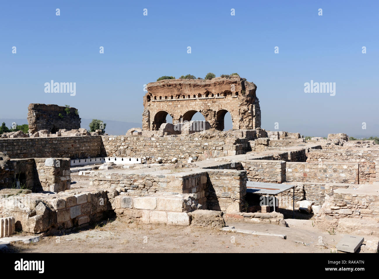 View towards the imposing three arched structure that is part of the Bath-Gymnasium complex, ancient city of Tralleis, Aydin, Anatolia, Turkey. Dated  Stock Photo