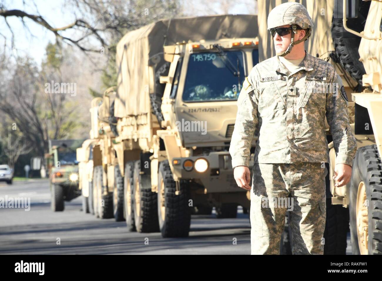 Spc. James Woodell of the 2632nd Transportation Company assists in ...