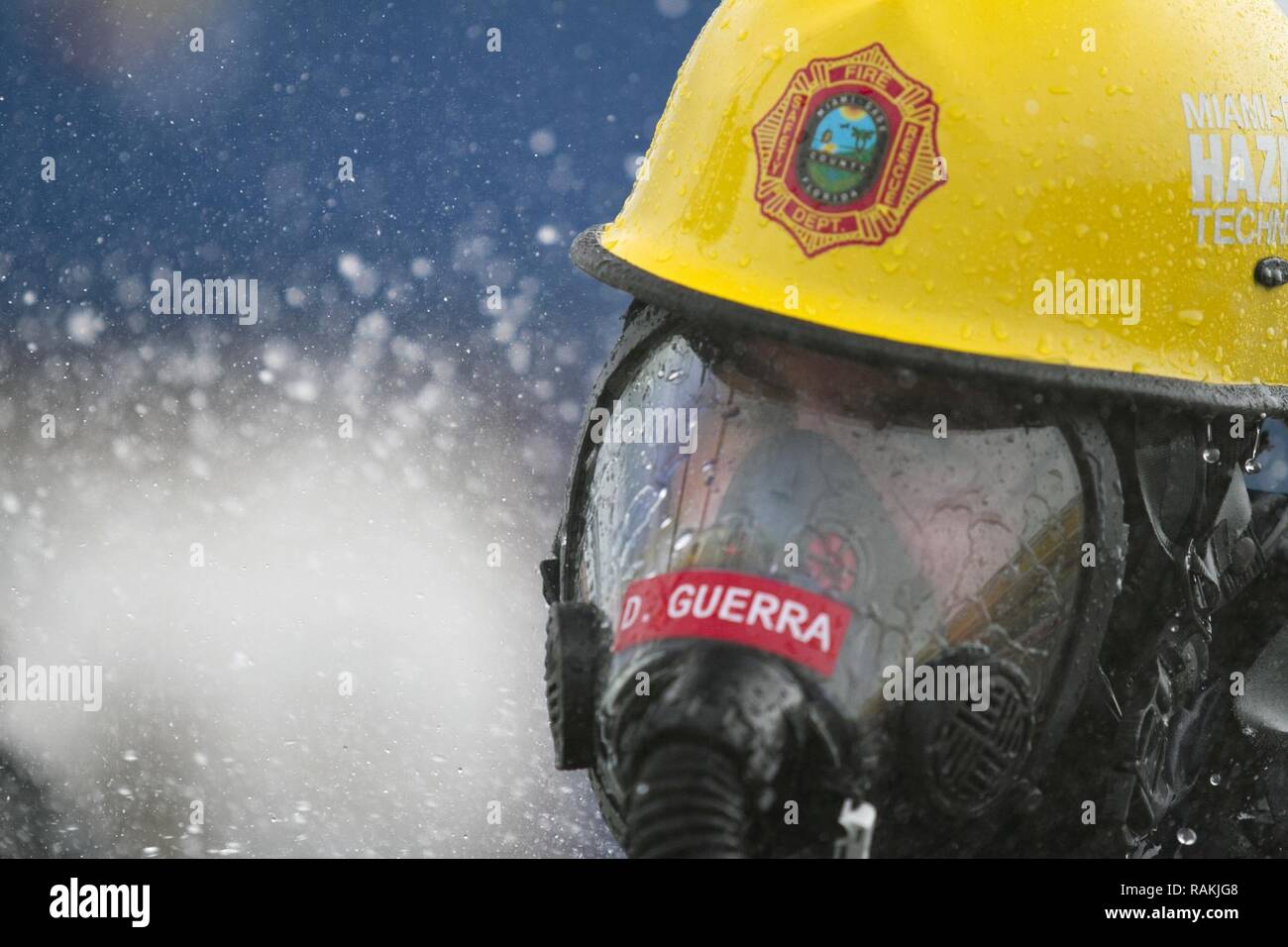 Firefighter David Guerra, a flight medic with the Miami-Dade Fire Rescue Department (MDFR), begins the decontamination process at the Port of Miami during a joint hazard material exercise with the Army Reserve’s 329th Chemical, Biological, Radiological, and Nuclear (CBRN) Company (Reconnaissance and Surveillance) on Feb. 18, 2017 in Miami, Fla. The 329th CBRN Company, from Orlando, Fla., the Army Reserve’s 469th Ground Ambulance Company, from Wichita, Kan., and the Florida National Guard’s Civil Support Team, spent the day training with MDFR firefighters during a sustainment training exercise  Stock Photo