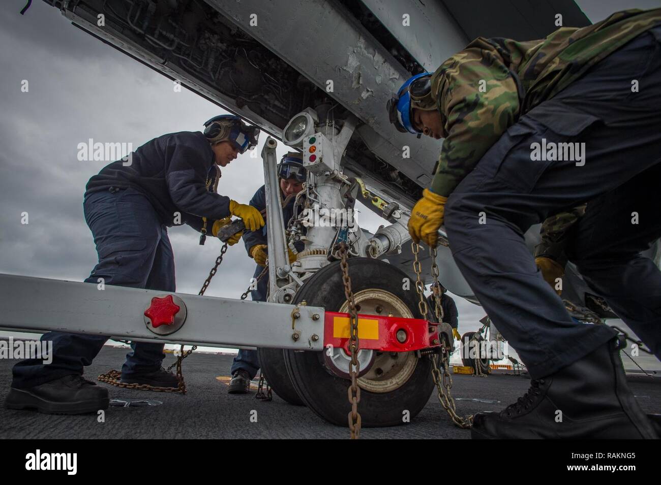 PACIFIC OCEAN (Feb. 17, 2017) Sailors use tiedown chains to secure a training jet on the flight