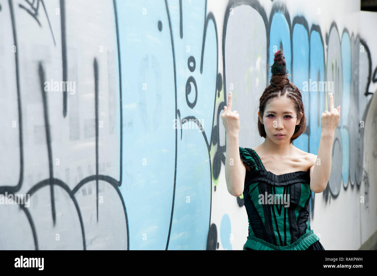 Asian female model poses for pictures on the street Stock Photo