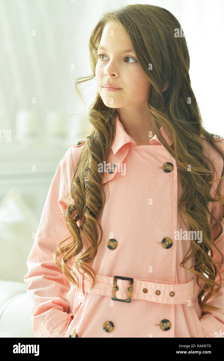 Cute little girl with long hair posing at home Stock Photo - Alamy