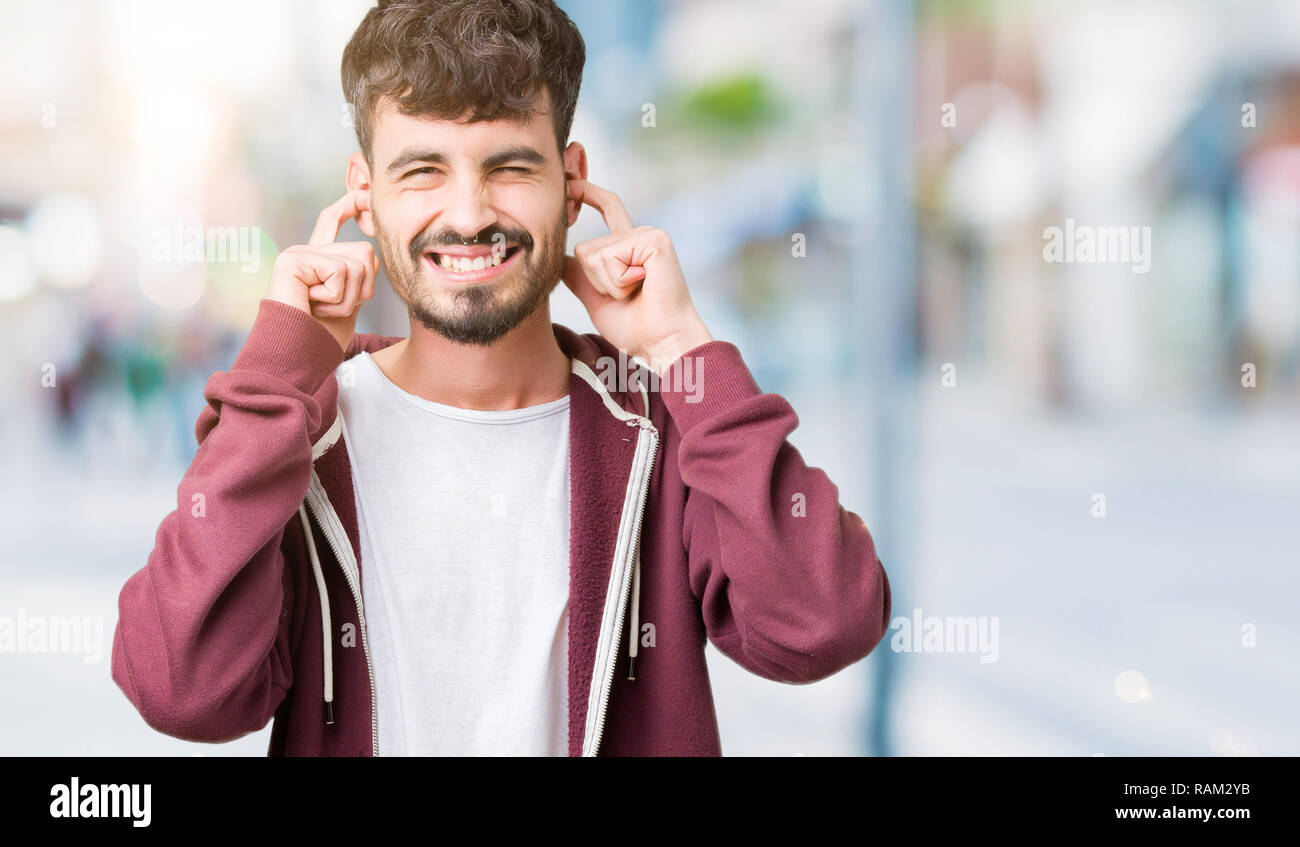 Young Handsome Man Over Isolated Background Covering Ears With Fingers With Annoyed Expression 