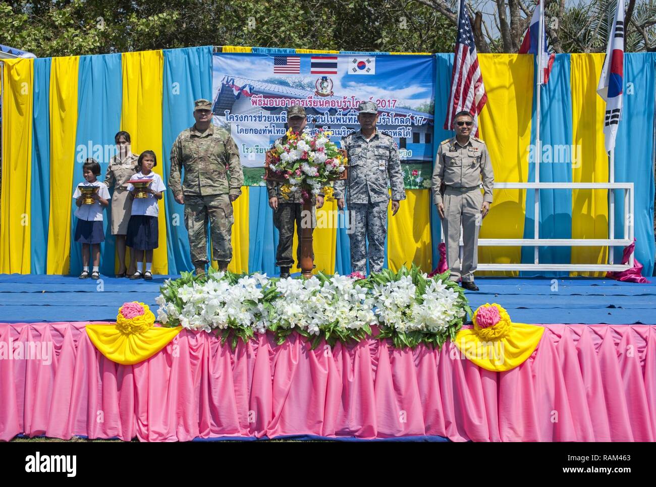 RAYONG PROVINCE, Thailand (Feb. 21, 2017) – (From left to right) Brig. Gen. Bryan Suntheimer, United States Army Pacific Deputy Commanding General for Army National Guard, Rear Adm. Jong Sam Kim, commander, Republic of Korea Navy Component 5, Vice Adm. Panya Lekbua, deputy commander-in-chief, Royal Thai Fleet and Gov. Surasak Charoensirichot, Rayong provincial governor stand on stage during a dedication ceremony, marking the completion of the Ban Nong Muang school expansion project. The project was a joint effort by the U.S. Naval Mobile Construction Battalion 5, Construction and Developmental Stock Photo