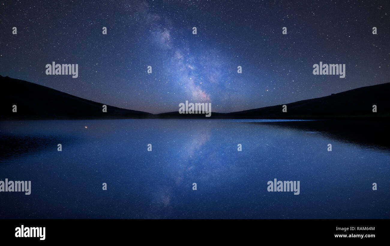 Stunning vibrant Milky Way composite image over landscape of calm lake ...