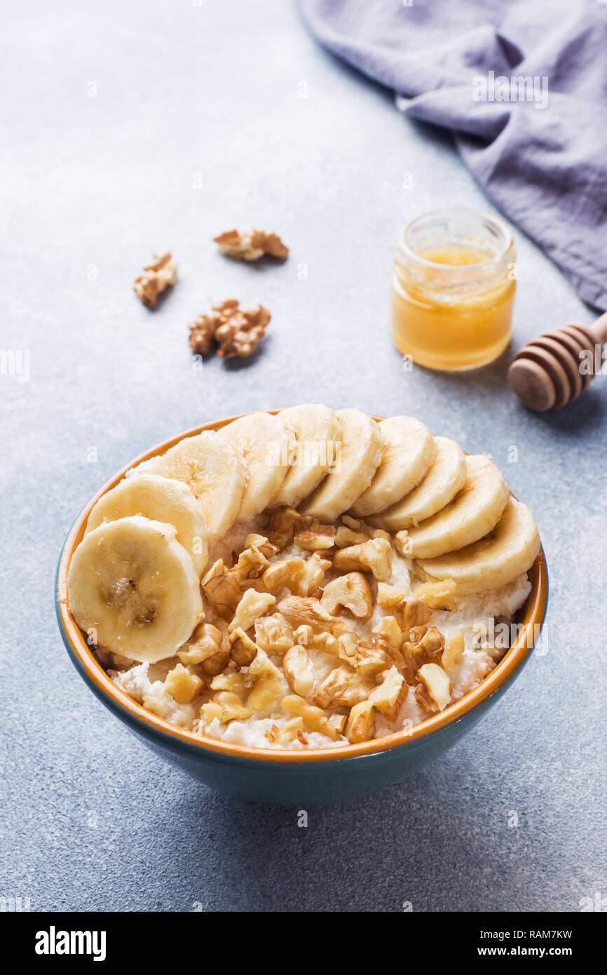 Healthy Breakfast Cottage Cheese With Banana And Walnuts On Grey