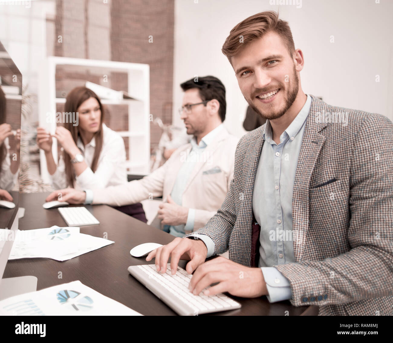 successful employee sitting at the Desk in the office Stock Photo Alamy