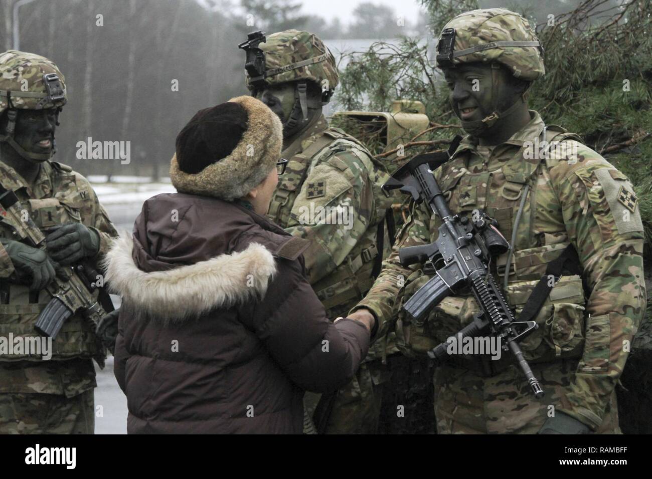 CAMP ADAZI, Latvia – U.S. Ambassador Nancy Bikoff Pettit shakes hands with Cpl. Nicholas Hodges, infantryman, 1st Battalion, 68th Armor Regiment, 3rd Armored Brigade, 4th Infantry Division, following a welcome ceremony hosted by the Latvian Land Forces at Camp Adazi, Latvia, Feb. 17, 2017. The arrival of 1-68 AR, in support of Operation Atlantic Resolve, marks the beginning of continuous U.S. armored brigade presence in Europe. Operation Atlantic Resolve is a U.S. led effort in Eastern Europe that demonstrates U.S. commitment to the collective security of NATO and dedication to enduring peace  Stock Photo