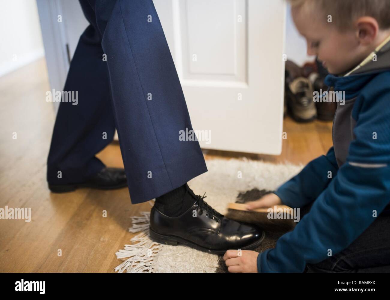 A grandson of Chief Master Sgt. Tom Kimball shines this chief's dress shoes hours before Kimball