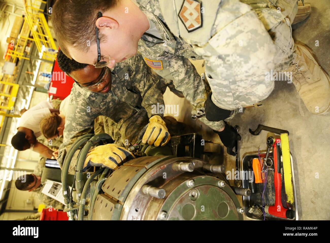 Spc. Christopher Norwood with the 275th Quartermaster Company at Fort Pickett, Va., and Sgt. Marquett Evans with the 422nd Civil Affairs Battalion at Greensboro, N.C., both students at Regional Training Site-Maintenance in the Wheeled Vehicle Mechanics Course, work on a project Feb. 10, 2017, at Fort McCoy. During the course, students learn to complete all basic concepts required to be certified as an Army wheeled-vehicle mechanic. This includes performing field-level maintenance on automotive wheeled vehicles and conducting wheeled-vehicle operations; receiving an introduction to troubleshoot Stock Photo