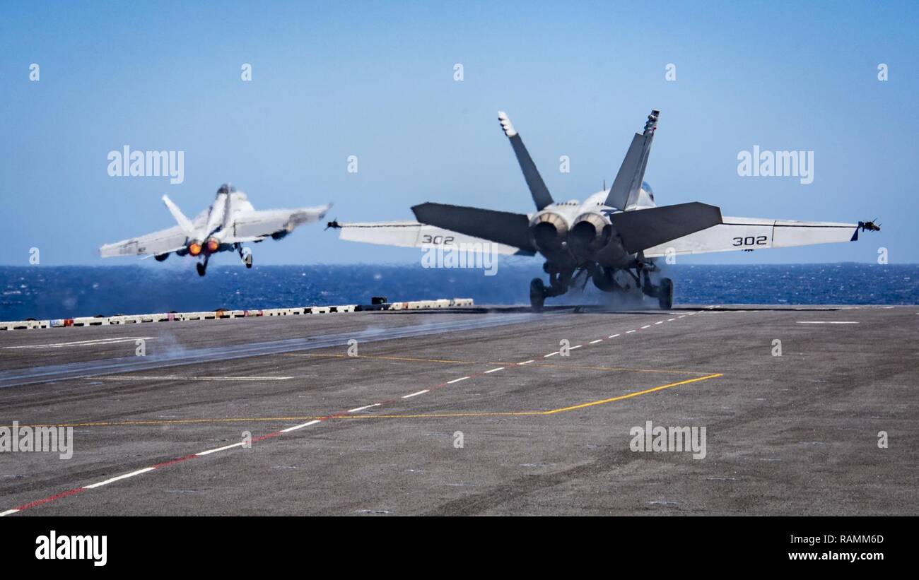 SOUTH CHINA SEA (Feb. 22, 2017) Two F/A-18F Super Hornets assigned to the “Bounty Hunters” of Strike Fighter Squadron (VFA) 2 and the “Golden Dragons” of Strike Fighter Squadron (VFA) 192 take off from the aircraft carrier USS Carl Vinson (CVN 70). The ship and its carrier strike group are on a western Pacific deployment as part of the U.S. Pacific Fleet-led initiative to extend the command and control functions of U.S. 3rd Fleet. Stock Photo