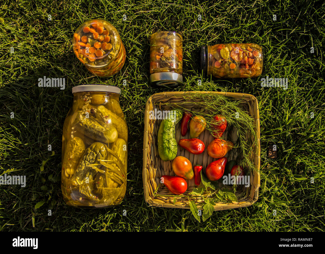 Marinated food. Assortment autumn preserves. Jars of pickled vegetables. Sealing farm vegetables in jars. Stock Photo