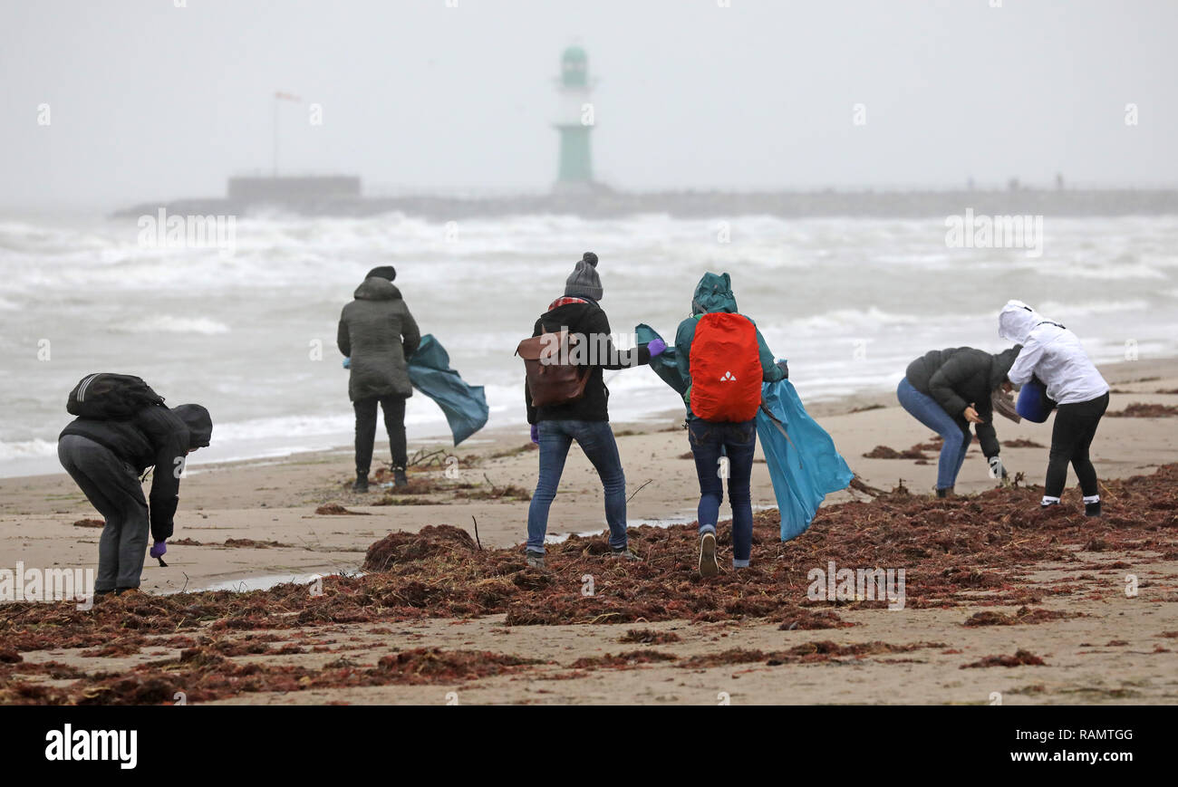 Warnemünde beach, Germany. 4th Jan 2019. Participants of a garbage collection campaign are on their way at the Baltic Sea beach. The campaign is organised by the Leibniz Institute for Baltic Sea Research (IOW). The aim is not only to collect the rubbish and remove the remains of the New Year's Eve fireworks, but also to analyse which types of rubbish are involved and where their source is. These data are processed scientifically. Photo: Bernd Wüstneck/dpa Credit: dpa picture alliance/Alamy Live News Stock Photo