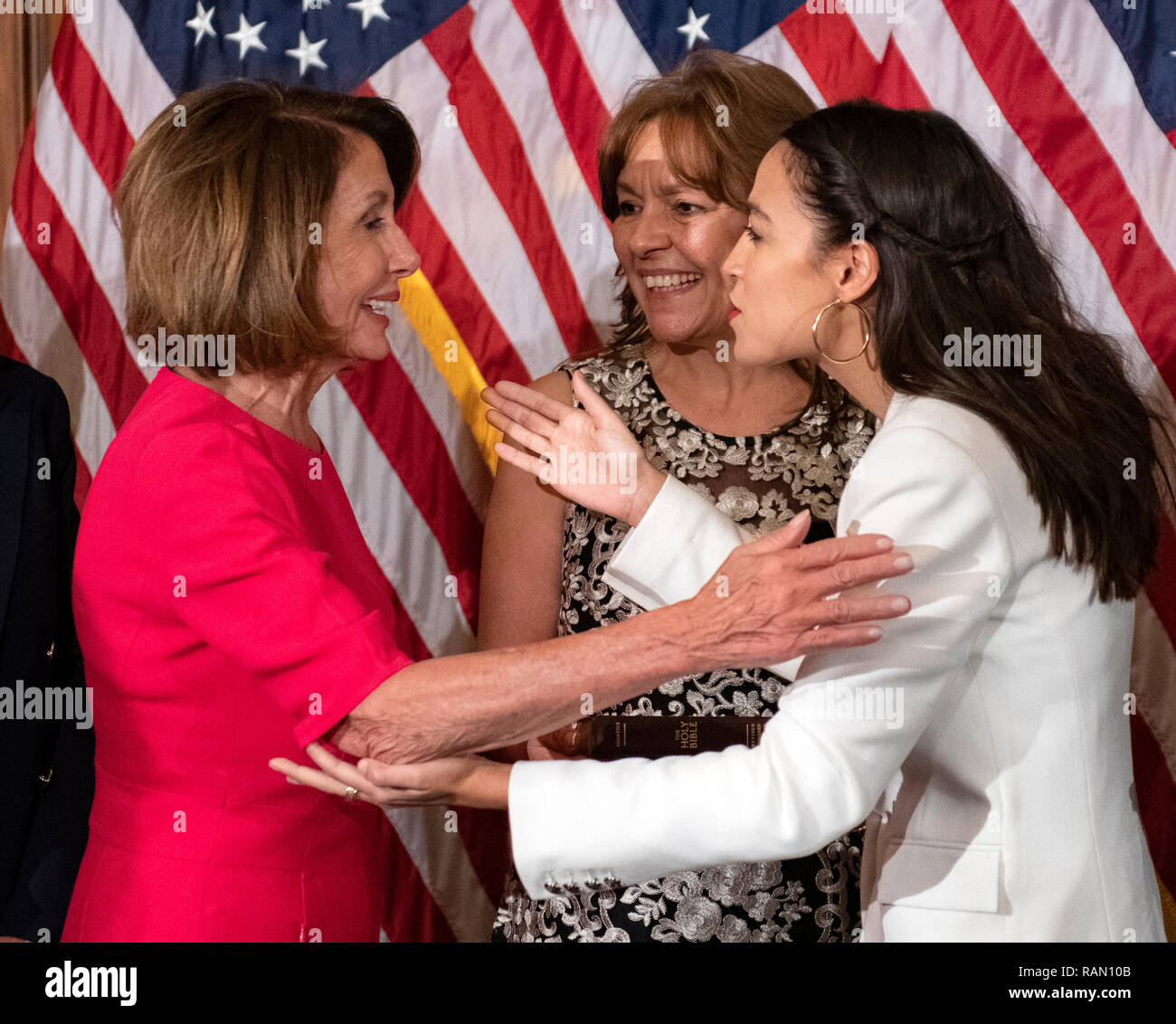Washington, United States Of America. 03rd Jan, 2019. United States Representative Alexandria Ocasio-Cortez (Democrat of New York) prepares to hug Speaker of the US House of Representatives Nancy Pelosi (Democrat of California) after posing for a mock swearing-in photo with members of her family as the 116th Congress convenes for its opening session in the US Capitol in Washington, DC on Thursday, January 3, 2019. Credit: Ron Sachs/CNP (RESTRICTION: NO New York or New Jersey Newspapers or newspapers within a 75 mile radius of New York City) | usage worldwide Credit: dpa/Alamy Live News Stock Photo
