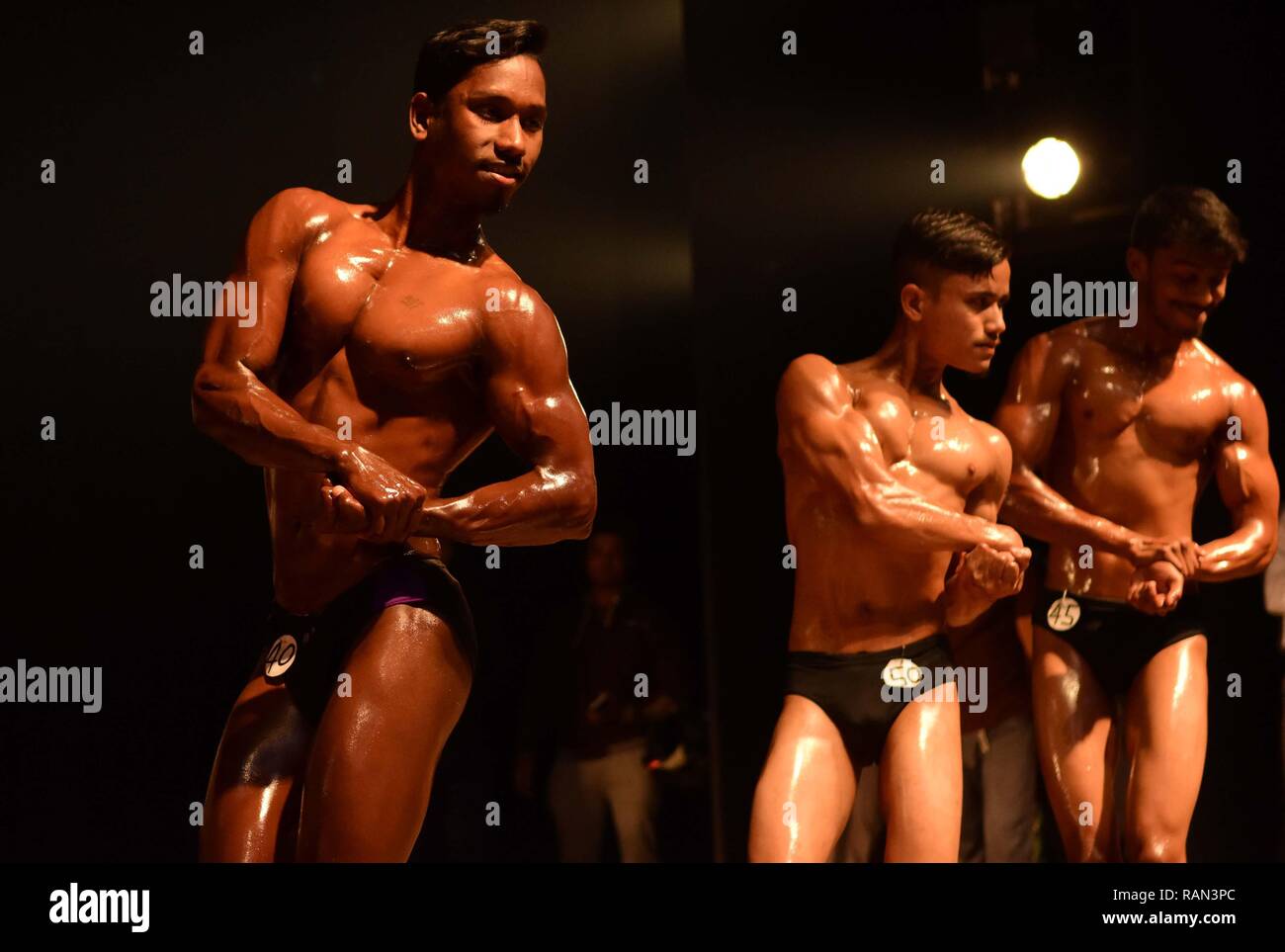Body builders seen on stage performing  on the occasion of 44th Tripura State Body Building championship organized by The  All Tripura Body Builders Association affiliated to Indian Body Building Federation. Stock Photo