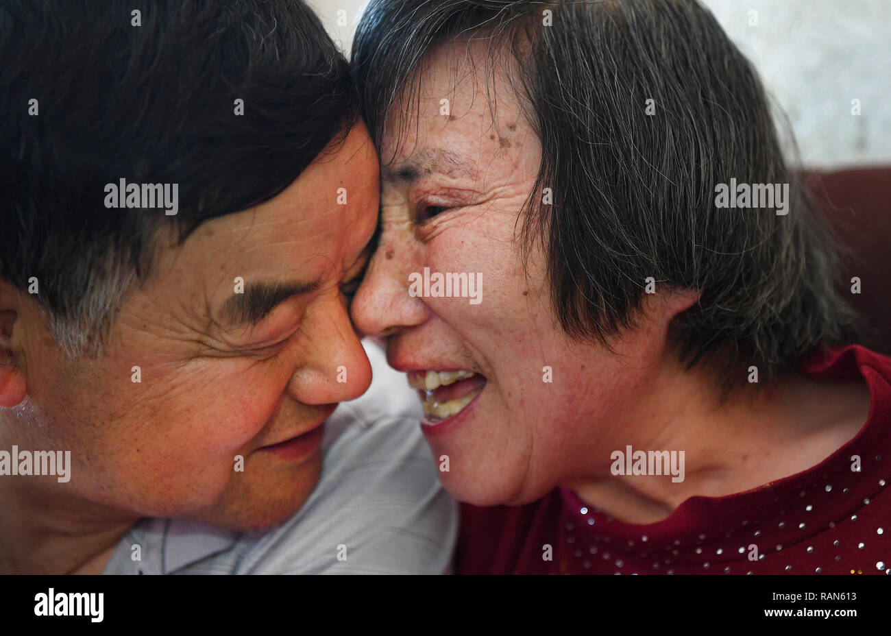 Beijing, China's Henan Province. 30th Apr, 2018. Yu Dongqin (R) tries to say thanks to her husband Duan Rongxian at home in Duanwan Village of Xinyang City, central China's Henan Province, April 30, 2018. Duan has taken care of his paralysed wife, who also has difficulty in speaking, for over 40 years. Credit: Tao Ming/Xinhua/Alamy Live News Stock Photo