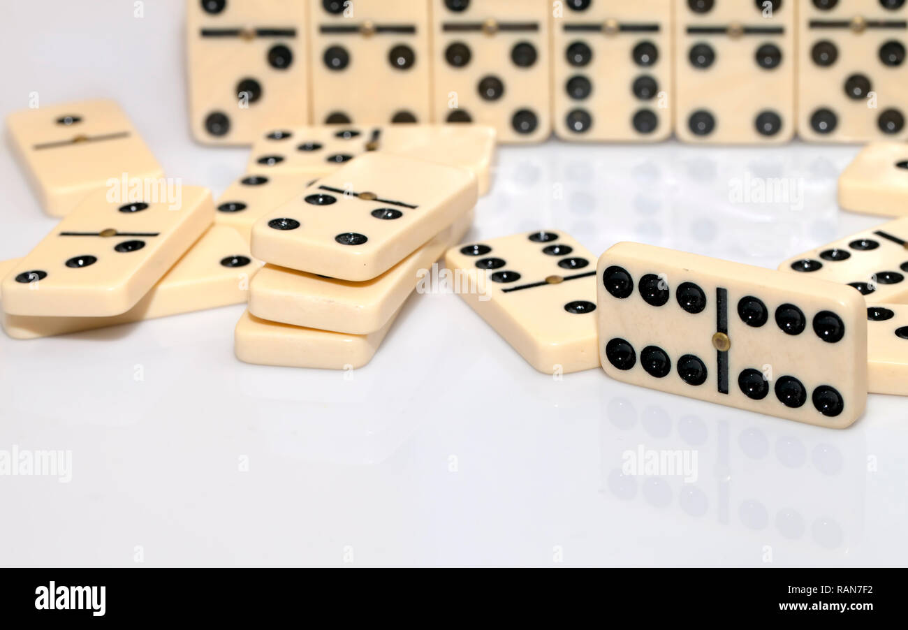 Domino Tiles Strategy Game Stones. Dominoes is a family of tile-based games  played with rectangular "domino" tiles. Each domino is a rectangular tile  Stock Photo - Alamy