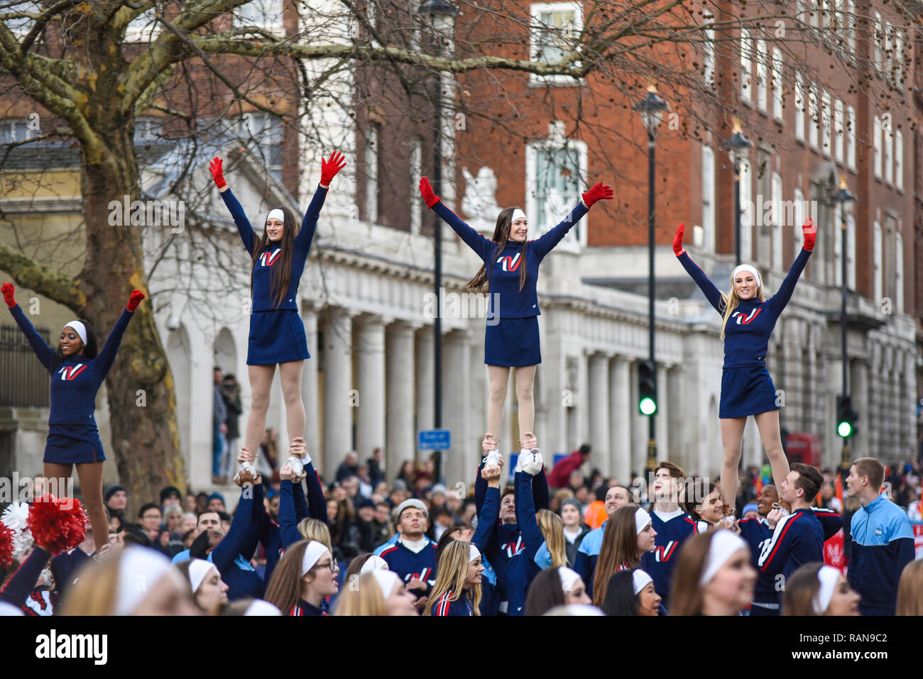 Varsity Spirit All American Cheerleaders at London's New Year's Day Parade, UK. Girls lifted high Stock Photo