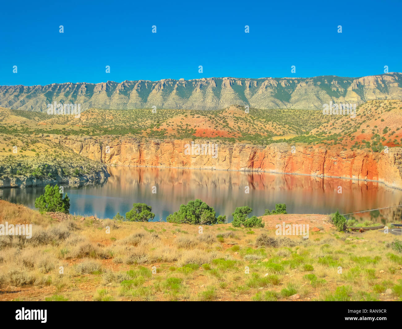 Bighorn Lake and orange Pryor Mountains at Bighorn Canyon National Recreation Area, a national park between Wyoming and Montana, United States. Blue sky with copy space. Stock Photo