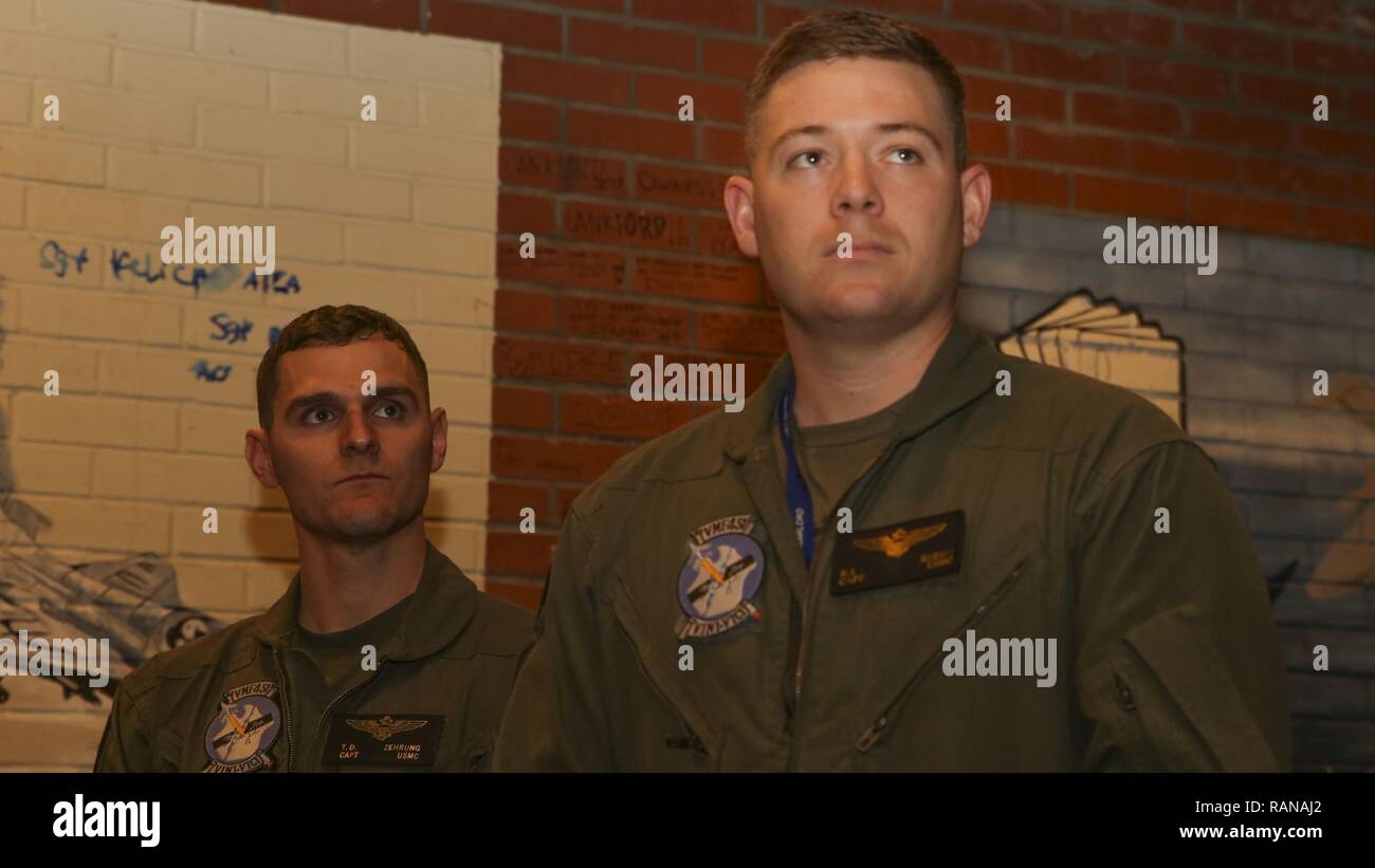 Peter Reddy Usmc Capt. Taylor Zehrung , left, and Capt. Robert Reddy, right, watch as ...