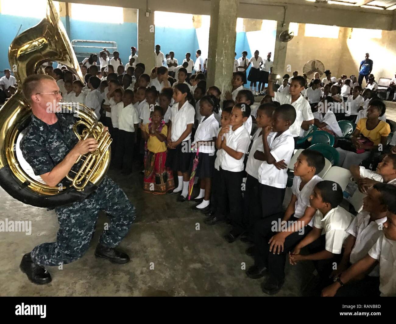SANTA FE, Honduras (Feb. 22, 2017) Musician 1st Class Christopher Jerome, assigned to the U.S. Fleet Forces Band, plays the sousaphone for host nation children in support of Continuing Promise 2017 in Trujillo, Honduras. CP-17 is a U.S. Southern Command-sponsored and U.S. Naval Forces Southern Command/U.S. 4th Fleet-conducted deployment to conduct civil-military operations including humanitarian assistance, training engagements, and medical, dental, and veterinary support to Central and South America. Stock Photo