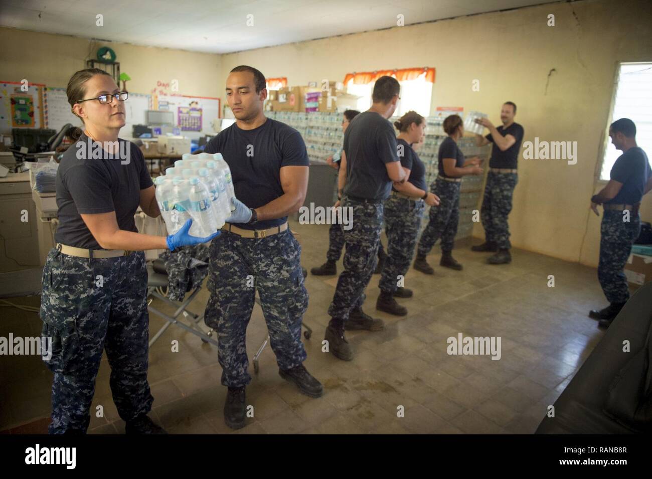 TRUJILLO, Honduras (Feb. 20, 2017) – Sailors pass drinking water at the Continuing Promise 2017 (CP-17) medical site in support of CP-17's visit to Trujillo, Honduras. CP-17 is a U.S. Southern Command-sponsored and U.S. Naval Forces Southern Command/U.S. 4th Fleet-conducted deployment to conduct civil-military operations including humanitarian assistance, training engagements, and medical, dental, and veterinary support in an effort to show U.S. support and commitment to Central and South America. Stock Photo