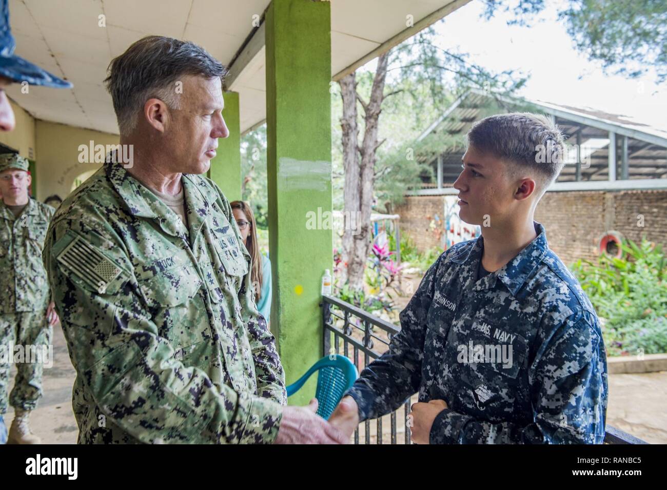 TRUJILLO, Honduras (Feb. 23, 2017) – Rear Adm. Sean S. Buck, Commander U.S. Naval Forces Southern Command/U.S. 4th Fleet NAVSO/FOURTHFLT), speaks with Hospitalman Kraylor Kirk-Johnson, a native of Laguna Beach, Calif., assigned to Naval Branch Health Clinic Jacksonville, Fla., during a tour of the Continuing Promise 2017 (CP-17) medical site in Trujillo, Honduras. CP-17 is a U.S. Southern Command-sponsored and U.S. Naval Forces Southern Command/U.S. 4th Fleet-conducted deployment to conduct civil-military operations including humanitarian assistance, training engagements, and medical, dental,  Stock Photo