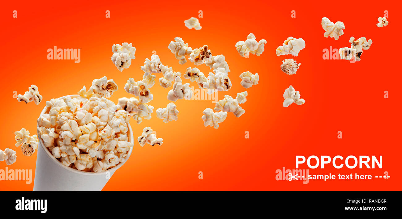 Popcorn in cardboard box, isolated on red background Stock Photo