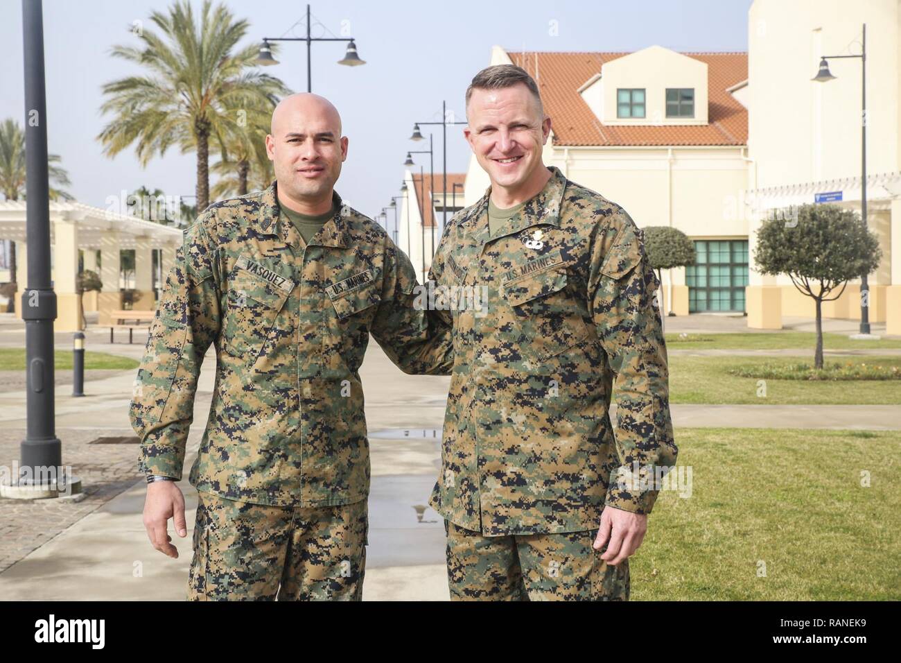 Gunnery Sgt. Juan Vasquez Jr., left, a U.S. Marine assigned to Special Purpose Marine Air-Ground Task Force – Crisis Response – Africa, poses for a photo with Col. Daniel Greenwood, the commanding officer of SPMAGTF-CR-AF, at Naval Air Station Sigonella, Italy, Feb. 25, 2017. Greenwood formerly served as the commanding officer for Marine Corps Recruiting Station Fort Lauderdale, Florida, while Vasquez was a poolee for the station in 2003. Stock Photo