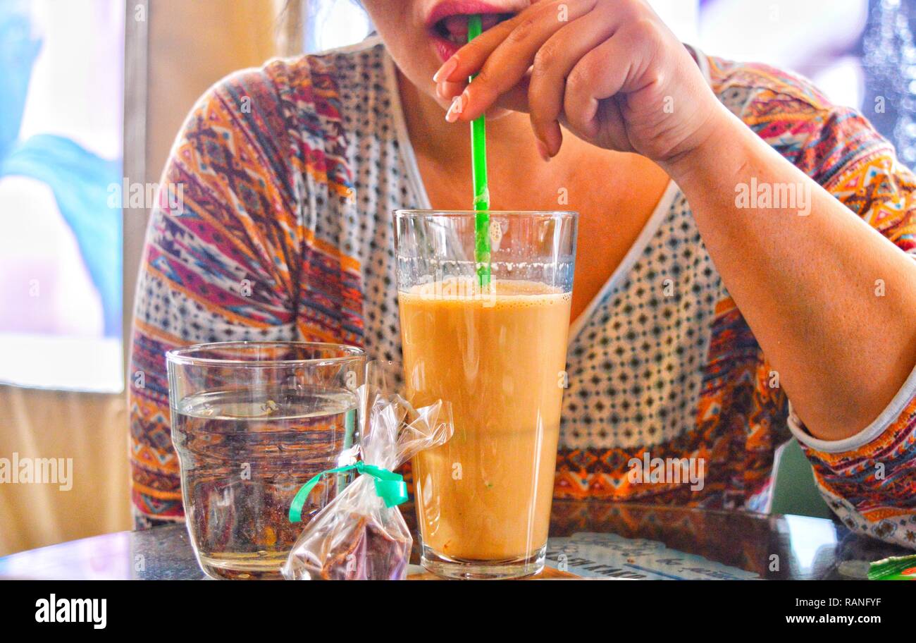 A person drinking coffee at a bar Stock Photo